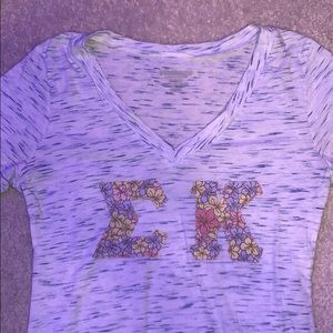 Blue and white v-neck sigma kappa shirt.